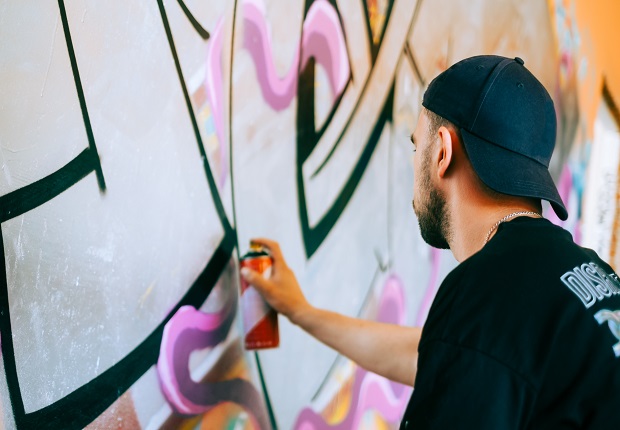 person målar graffiti